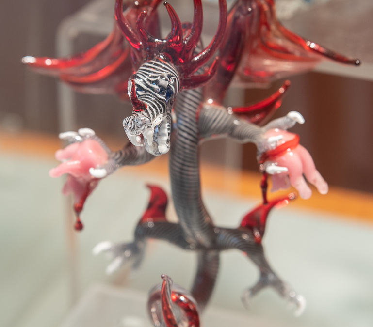 Glass dragon tearing apart pig