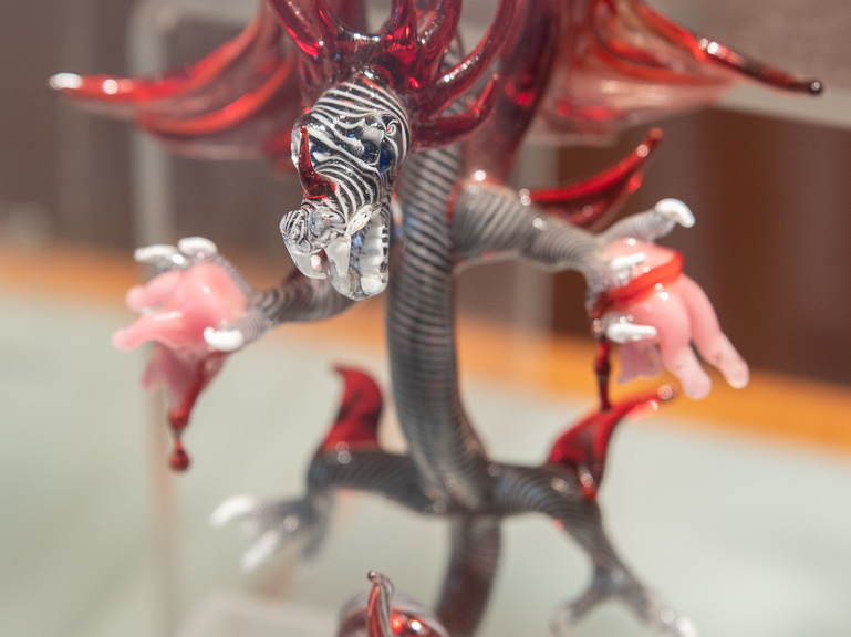 Glass dragon tearing apart pig